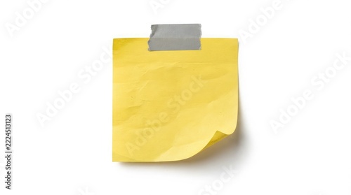 Isolated yellow sticky note with a metal paper clip attached on a plain white background for graphic design projects