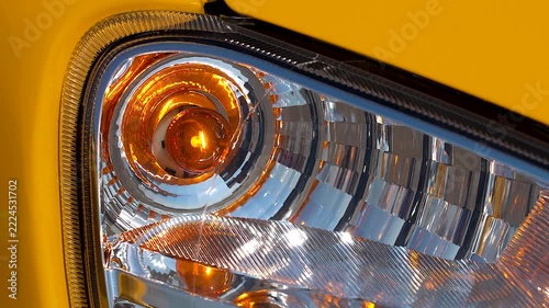 Amber turn signal on a yellow car.