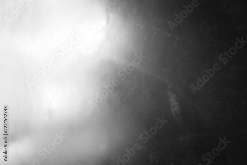 Abstract black and white background with soft light and textured surface