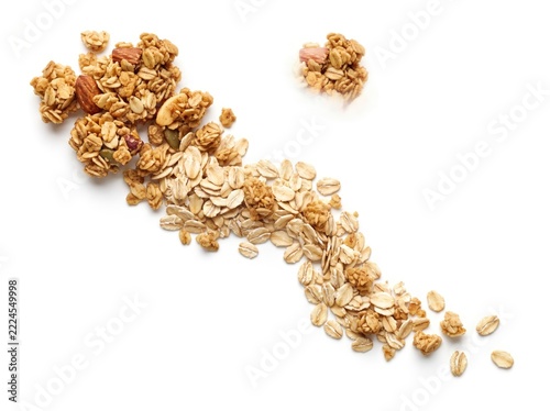 Freshly poured oats and granola cluster on clean white background for