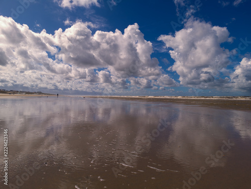 Netherlands - 10 september 2026, Zandvoort: Blue Sky and Cloud Reflections on Coastal Beach Strand