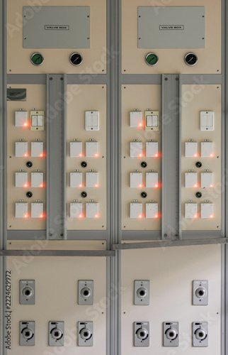 Two medical supply panels have labeled oxygen and air outlets, pressure gauges and electrical sockets with illuminated indicators