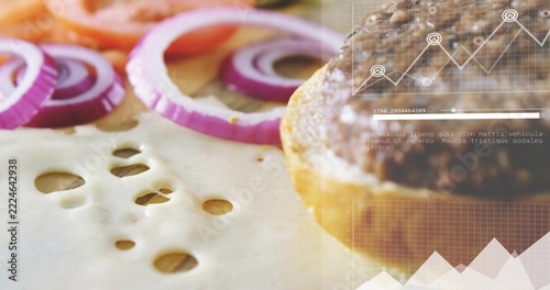 Showing cooked beef patty on bottom bun at tabletop, Swiss cheese, onions and overlay, copy space