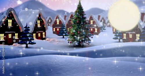 Glowing decorated evergreen tree twinkling with lights in snowy village at dusk, with cottages