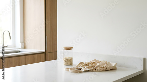 A clean and modern kitchen countertop with a jar of food and a towel
