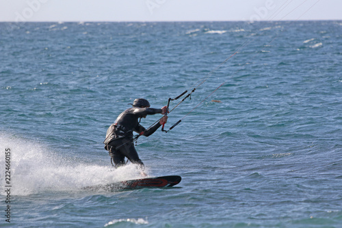 kitesurfer riding his board on the sea	
