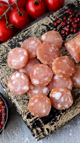 Sliced dry cured chicken sausage or smoked meat with salt and spices. Sliced smoked chicken sausage