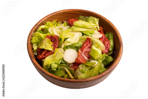 Mixed salad with lettuce, tomatoes in wooden bowl isolated on white. side view, close up