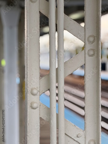 Close view of an old white metal gate