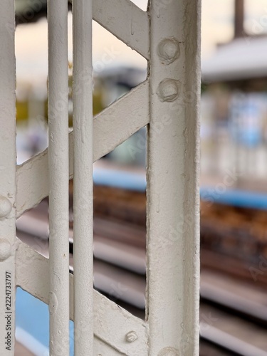 White Metal Bridge Railing Above Railway Tracks