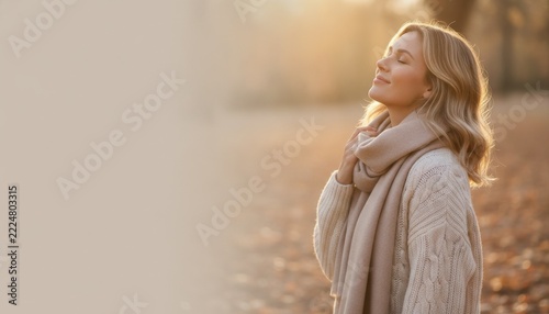 Woman enjoying autumn sunshine in cozy knitwear outdoors