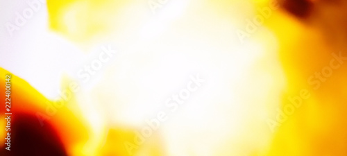 Vibrant abstract background with bright yellow and warm golden light flares