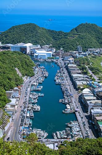 Under the blue sky, overlooking the Nanfangao Fishing Harbor filled with moored fishing boats.