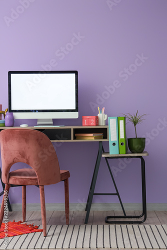 Remote work and home office setup, computer with blank screen on desk with st...