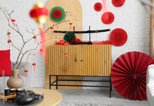 Interior of living room with katana on drawers and decor for Chinese New Year...