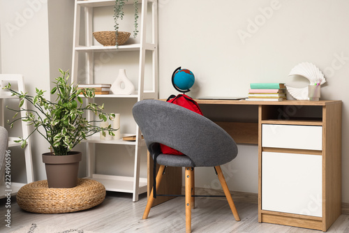Remote learning and home schooling environment, student desk with backpack an...