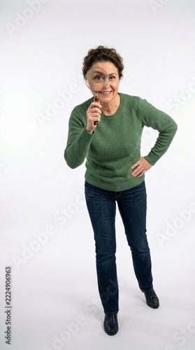 Curious woman examining with magnifying glass isolated on white background Investigation discovery curiosity concept