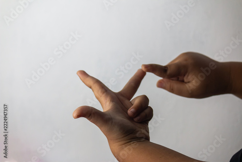 Child hands counting with fingers gesture for early math learning against a plain white background with copy space