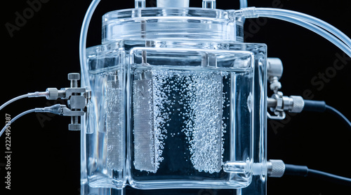 Laboratory Water Electrolysis Experiment Demonstrating Hydrogen Gas Production with Bubbles in Clear Glass Reactor