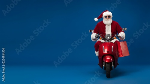 Stylish santa claus riding red scooter with shopping bag for christmas retail promotion and holiday sales campaign