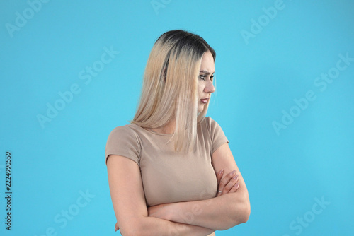 Fotografie Displeased Young Woman Standing with Folded Arms