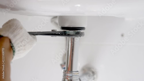 Repairing shink or washbasin drain.