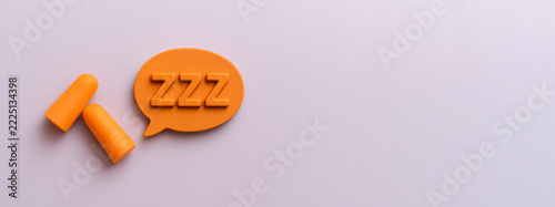 Sleep problem concept with earplugs and zzz symbol, ideal for health background