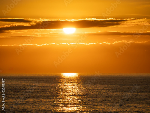 Sunset casting a shimmering reflection over Bideford Bay