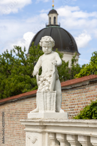 One of baroque putto (cherub) figures in Belvedere Gardens, Vienna, Austria