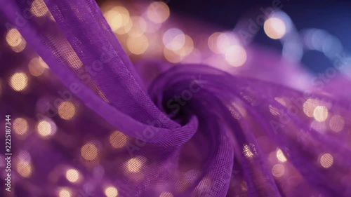 Dreamy purple sheer fabric with sparkling bokeh lights, creating a magical abstract background.