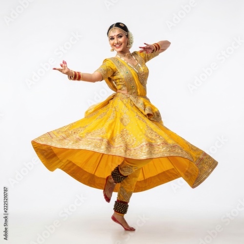 Happy indian woman dancing in a traditional yellow dress with gold embroidery isolated on white background