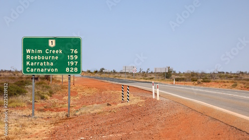 Road sign on National Route 1 with distances to Whim Creek, Roebourne, Karratha, Carnarvon. Pilbara region, Outback, Western Australia, known for mining and tourism
