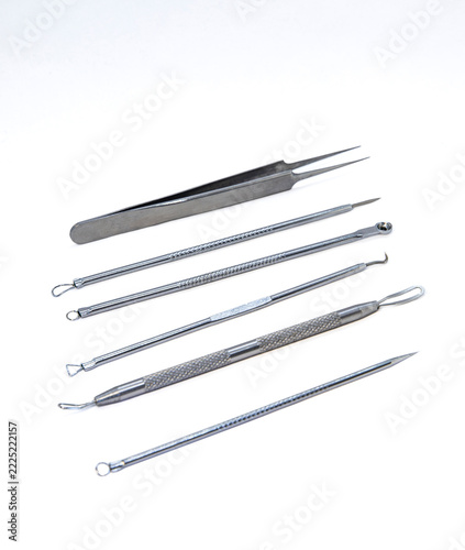 Set of metal tools for face cleaning and blackhead removal on white background