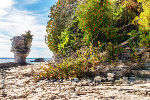 Scenic limestone flowerpot rock formation on the rocky shore of Flowerpot Island in Fathom Five National Marine Park, Lake Huron, Ontario, Canada.