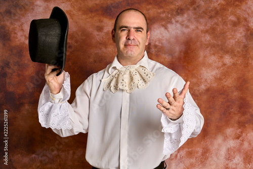 Elegant man posing in in 19th-century Victorian gown 