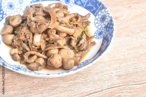 fried slice oyster and straw mushroom with soy sauce vegetarian food on plate