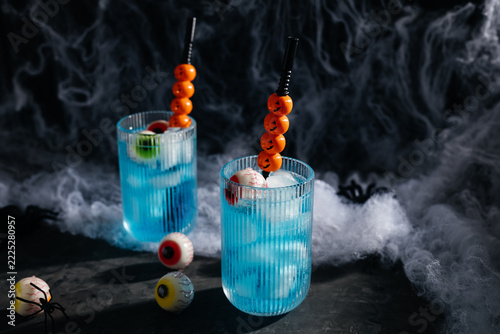 Halloween cocktails with spooky eyeballs and pumpkin straws
