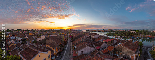 • Stunning panorama of Hoi An ancient town at sunrise, peaceful Thu Bon river from above, UNESCO World Heritage site, Vietnam.