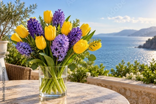 Yellow Tulips and Purple Hyacinths in a Glass Vase Beside a Calm Blue Sea