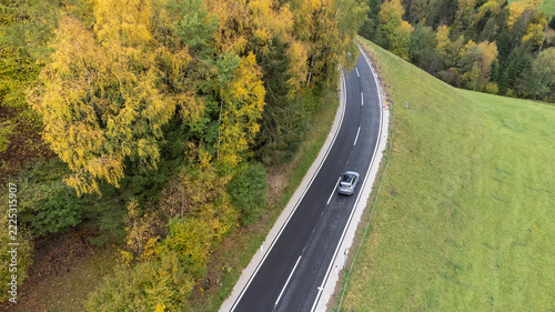 aerial shot of car on a road in a rural area in Styria, Austria