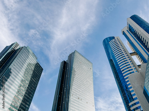 Rising above city streets, modern glass skyscrapers define Astana skyline with contemporary architecture, reflective facades and urban development, Kazakhstan