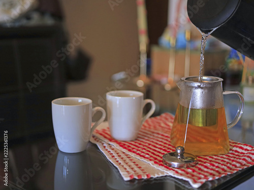 Water pouring into glass teapot, tea brewing and hot beverage preparation breakfast in food and beverage service. Home hospitality and a passion for tea culture.