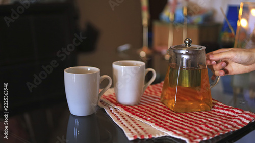 Glass teapot and ceramic white mugs, beverage service and hospitality tableware for brewing and serving tea at home
