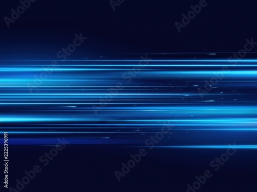 Blue light streaks motion blur against dark background for abstract technology concept