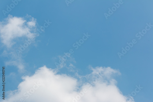 Blue sky with soft white fluffy clouds in daytime and large empty copy space for text, natural background
