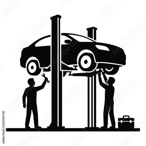 Silhouette of two mechanics working on a car raised on a hydraulic lift in a garage
