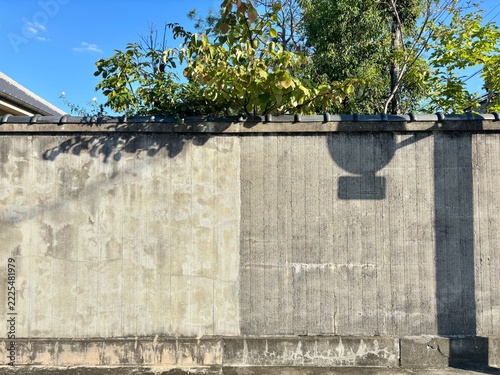 Road Sign Shadow on a Weathered Concrete Wall