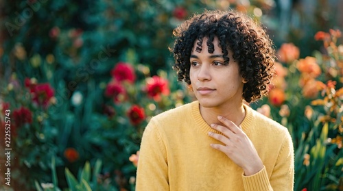 Portrait of a Person in a Yellow Sweater Sitting in a Blooming Garden