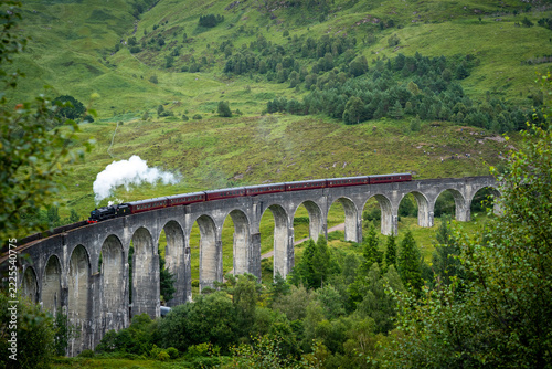 The Glenfinnan Viaduct across a green Highland valley