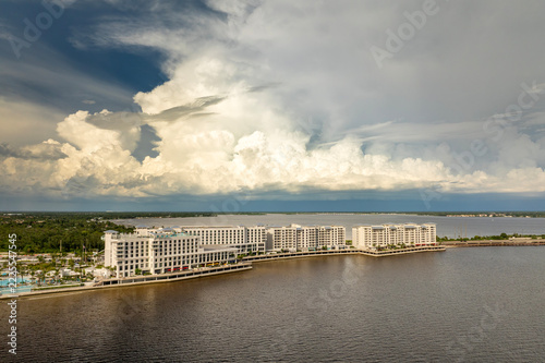 Tourists forced indoors at bay shore resort before hurricane storm. Interrupted vacation caused by extreme weather conditions.